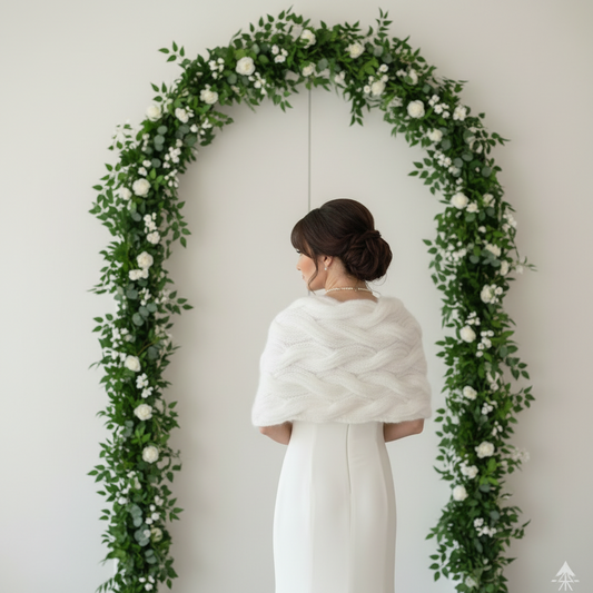 Ivory hand-knit mohair bridal wrap worn over a wedding dress, soft and elegant bridal shawl